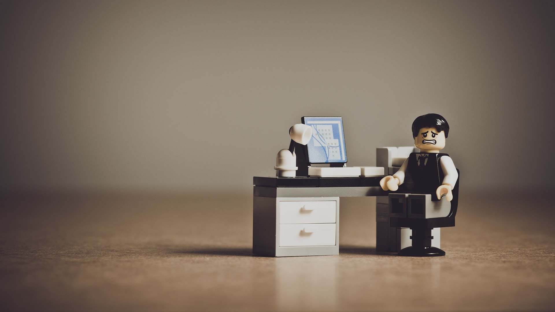 Illustrative image of lego figure with a broken computer